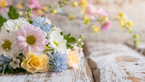 Fototapeta Tęcza - Colorful spring flowers on rustic light wooden planks with copy space for text. Celebration concept