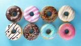 Fototapeta Tęcza - Various colourful donuts on blue background