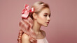 © triocean - Beautiful young woman with wavy pastel pink colored hair	and satin pink bow hairclip