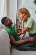 © LIGHTFIELD STUDIOS - portrait of joyful deaf african american woman in hearing aid device smiling near boyfriend at home