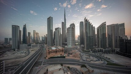 Wall Mural - Aerial panoramic view of Dubai Downtown skyline with many towers night to day transition timelapse. Business area in smart urban city. Skyscrapers and high-rise buildings from above before sunrise UAE