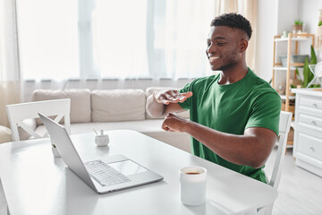 joyful deaf african american freelancer using sign language for communication during video call