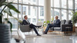 © Studio Zenith - deux hommes d'affaires discutant dans un bureau vitré donnant sur la ville