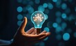 © Xin Yan - Creativity and smart thinking concept holding virtual light bulb on bokeh background