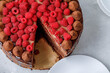 Piece of chocolate truffle cake with fresh ripe raspberries on top. Flat lay.
