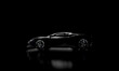 © tiero - side view of black supercar on dark background. nobody.