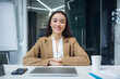 © Ivan - Beautiful young business woman smiling at camera. European confident good looking female businessperson on office background, copy space.