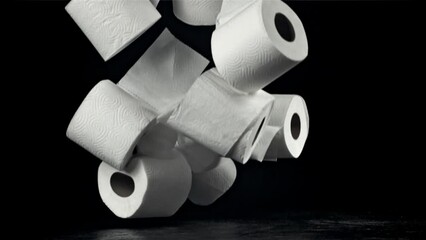 Sticker - Toilet paper falls on the table. On a black background. Filmed on a high-speed camera at 1000 fps. High quality FullHD footage