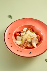 Canvas Print - Elegant Caesar salad with grilled chicken on a coral plate, a refreshing choice for a healthy meal