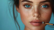© tbralnina - Closeup portrait of a woman applying cosmetic on the face.