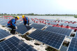 © ultramansk - Photovoltaic engineers work on floating photovoltaics. workers Inspect and repair the solar panel equipment floating on water. Engineer working setup Floating solar panels Platform system on the lake.