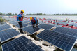 © ultramansk - Male workers repair Floating solar panels on water lake. Engineers construct on site Floating solar panels at sun light. clean energy for future living. Industrial Renewable energy of green power.