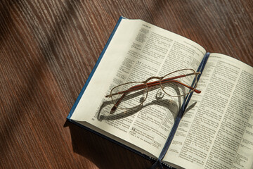 Wall Mural - Holy Bible, eyeglasses. Lifestyle, natural aesthetic light.