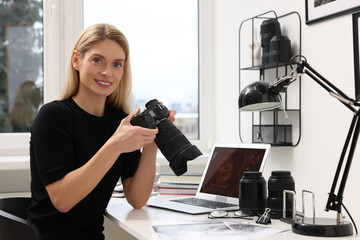 Poster - Professional photographer with digital camera at table in office