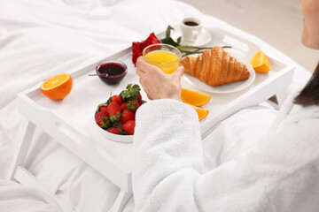 Wall Mural - Woman having breakfast in bed at home, closeup