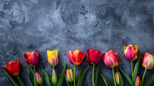 Red And Yellow Tulips On A Wooden Background