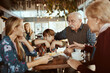 © Davor - Multigenerational family sitting in a cafe together