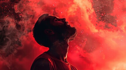 Wall Mural - Portrait of a young man praying against a background of red smoke. Worship.