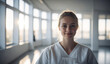 Confident Young Norwegian Female Doctor or Nurse in Clinic Outfit Standing in Modern White Hospital, Looking at Camera, Professional Medical Portrait, Copy Space, Design Template, Healthcare Concept