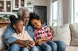 © nutalina - Modern elderly African Americans hugging and spending time with their grandchildren