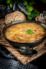 Canvas Print - Pea soup with pieces of white sausage, potatoes and small dumplings.