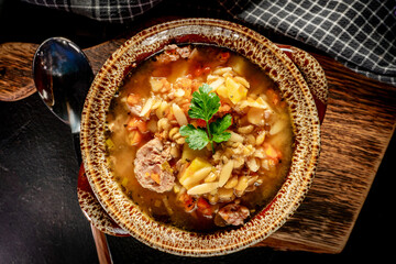 Canvas Print - Pea soup with pieces of white sausage, potatoes and small dumplings.