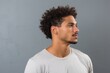 © Serhii - Side Portrait of Attractive African American Man Staring with Blank Background and Casual Attire.