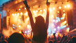 © Annemarie - womman dancing with hands in the air in front of big stage at a cool rock music festival. Person dancing in the crowd with hand up at a live concert.