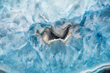 Blue crystals Agate mineral Macro. Stone surface background.