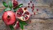 fresh juicy pomegranate whole and cut with leaves on a wooden vintage background top view horizontal with copy space