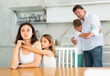 © JackF - Upset family with son and daughter arguing in kitchen at home