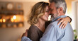 © Elena - Happy middle aged couple embracing at home, intimate moment, in love