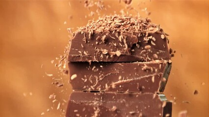 Wall Mural - The grated chocolate falls on the chocolate slices. Filmed on a high-speed camera at 1000 fps. High quality FullHD footage