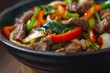 Beef and vegetable stir fry cooked in an Asian wok