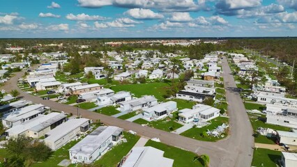 Poster - Severely damaged houses after hurricane in Florida mobile home residential area. Consequences of natural disaster