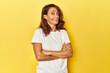 Middle-aged woman on a yellow backdrop suspicious, uncertain, examining you.