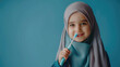 Beautiful young muslim girl holding tootbrush as a concept of health education from an early age