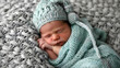 Peaceful Slumber: Serene Newborn Baby in Teal Blanket and Gray Hat