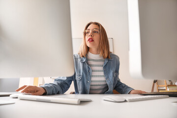 Female programmer working with computer at table in office