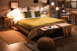© Pixel-Shot - Interior of stylish bedroom with green blanket on bed and glowing lamps at night