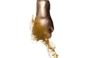 Boxing glove hit sand and explode. White Boxer glove impact gold yellow sand splash as exercise training. White background isolated