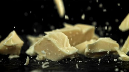 Wall Mural - Chunks of white chocolate fall on the table. Filmed on a high-speed camera at 1000 fps. High quality FullHD footage