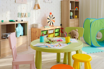 Sticker - Interior of playroom with table and toys in kindergarten