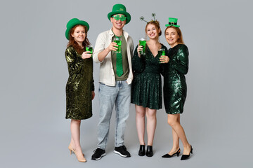 Poster - Group of people with beer on light background. St. Patrick's Day celebration