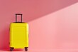 A rectangle yellow suitcase contrasts with a magenta wall