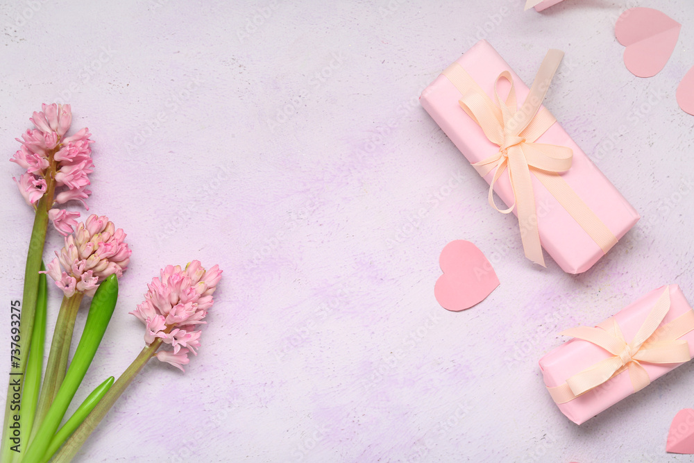 Frame made of hyacinths and presents on light background