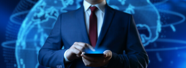 Wall Mural - A businessman holds a smartphone. Business Technology Concept