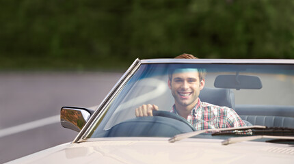 Poster - Happy man, portrait and driving car for road trip, travel or adventure on outdoor adventure. Young male person with smile in vehicle for transportation, holiday getaway or drive on street in nature