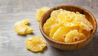 Wall Mural - Dried pineapple in a bowl. Dried fruits.. Selective focus.