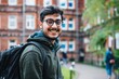 © Lukasz Czajkowski - Man With Glasses and Backpack Standing in Front of University Building. Generative AI.